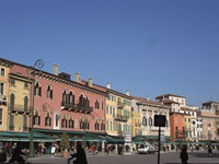 Blick auf die von bunten Hausfassaden gesäumte Piazza Bra in Verona.
