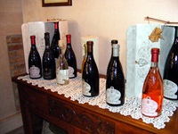 Verrschiedene Weine des Weingutes Cà dei Frati stehen in einem Restaurant auf einem hölzernen Tisch.