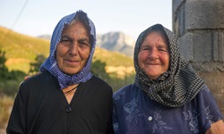 Zwei ältere einheimische Frauen mit Kopftuch posieren in der Südlichen Griechischen Ägäis für ein Foto.