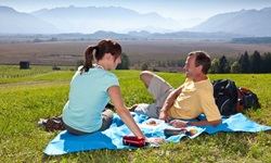 Ein junges Paar genießt ein Picknick bei Murnau.
