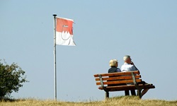 Zwei Personen sitzen auf der Bank an der Aussichtsplattform auf dem Staffelberg in Bad Staffelstein