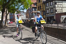 Ein Radlerpärchen erfreut sich an der Schönheit der Colmarer Altstadt.