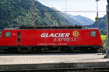 Blick auf die rote Bahn "Glacier Express" von St. Moritz / Davos nach Zermatt in Disentis am Bahnhof