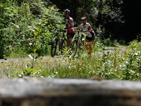 Ein Radlerpaar schiebt ihre Montainbikes durch den Schwarzwald