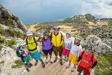 Eine Gruppe von Mountainbikern posiert auf dem Gipfel des Veitsberges (Vidova Gora) auf der Insel Brac für ein Foto.