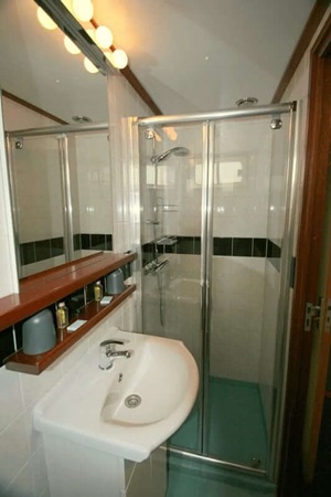 Blick in ein Badezimmer mit Dusche, Waschbecken und Spiegel auf der MS La Mar
