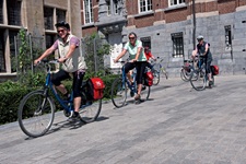 Eine Radlergruppe fährt durch ein Städtchen in Flandern.