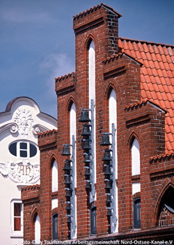Blick auf einen Giebel mit Klinkersteinen und Glocken
