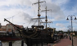 Ein zweimastiger, an ein Piratenschiff erinnernder Holzsegler im Hafen von Leba.