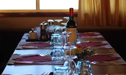 Festlich gedeckter Tisch mit Gläsern und Weinflasche im Restaurant der MS Bordeaux.