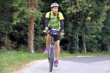 Ein Radler fährt auf einem asphaltierten Radweg durch einen Wald in Istrien.