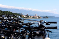 Leihräder an Bord des Motorseglers Linda. Im Bildhintergrund ist die Skyline von Rab Stadt zu erkennen.