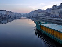 Ein Schiff fährt über die Rhone in Lyon - links und rechts die Promenade