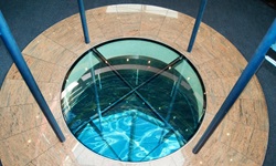 Der Glasboden im Atrium der MS Primadonna gibt den Blick auf die Wasser der Donau frei.