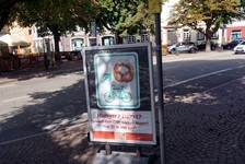 Blick auf ein Schild, das den Neckar-Radweg mit einer Brezel zeigt und an einer Bäckerei vorbei führt
