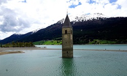 Der Kirchturm von Alt-Graun ragt als Mahnmal aus dem Reschensee hervor.