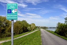 Grünes Donauradweg-Hinweisschild bei Mauthausen.