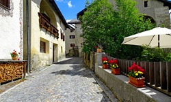 Typische Engadiner Häuser säumen eine enge Gasse im Künsterdorf Guarda.